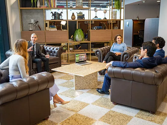 Professionals are gathered in Servcorp’s elegant coworking space. 