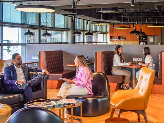 Professionals are gathered in Servcorp’s elegant lounge area