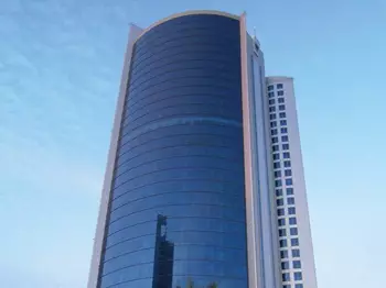 The iconic Bahrain Financial Harbour, a striking example of modern architecture with its twin towers soaring into a blue, cloud-dotted sky—home to prestigious Servcorp serviced offices,