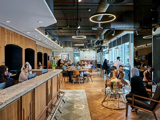 Servcorp at Olaya Towers features a vibrant coworking space with a welcoming reception, modern design, and a collaborative atmosphere ideal for business professionals.