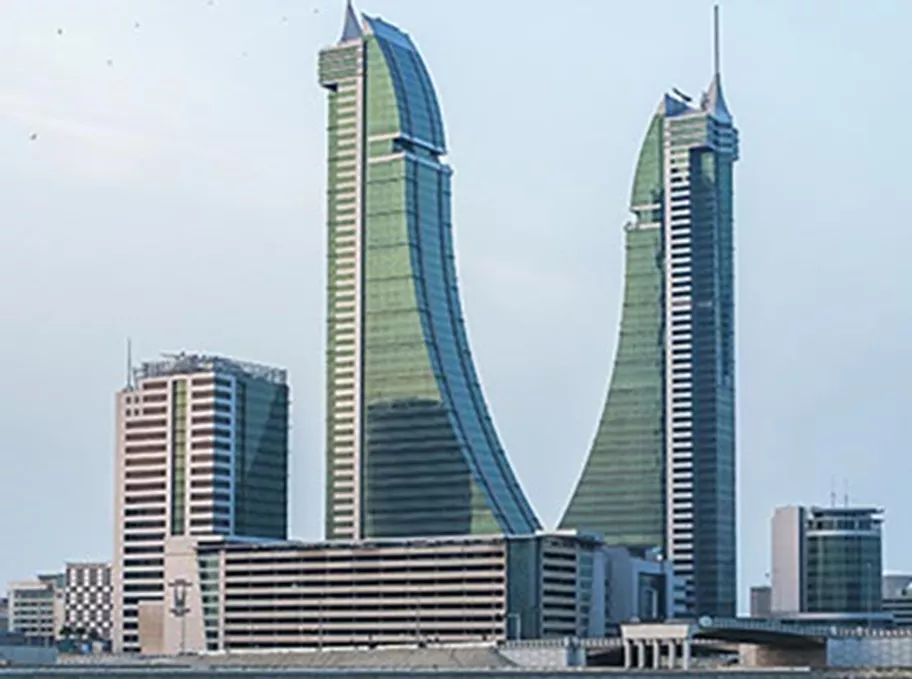 A stunning waterfront view of Bahrain Financial Harbour, with its distinctive twin towers rising gracefully against the skyline—home to Servcorp serviced offices,